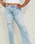 Light blue jeans worn by a person on a light gray background