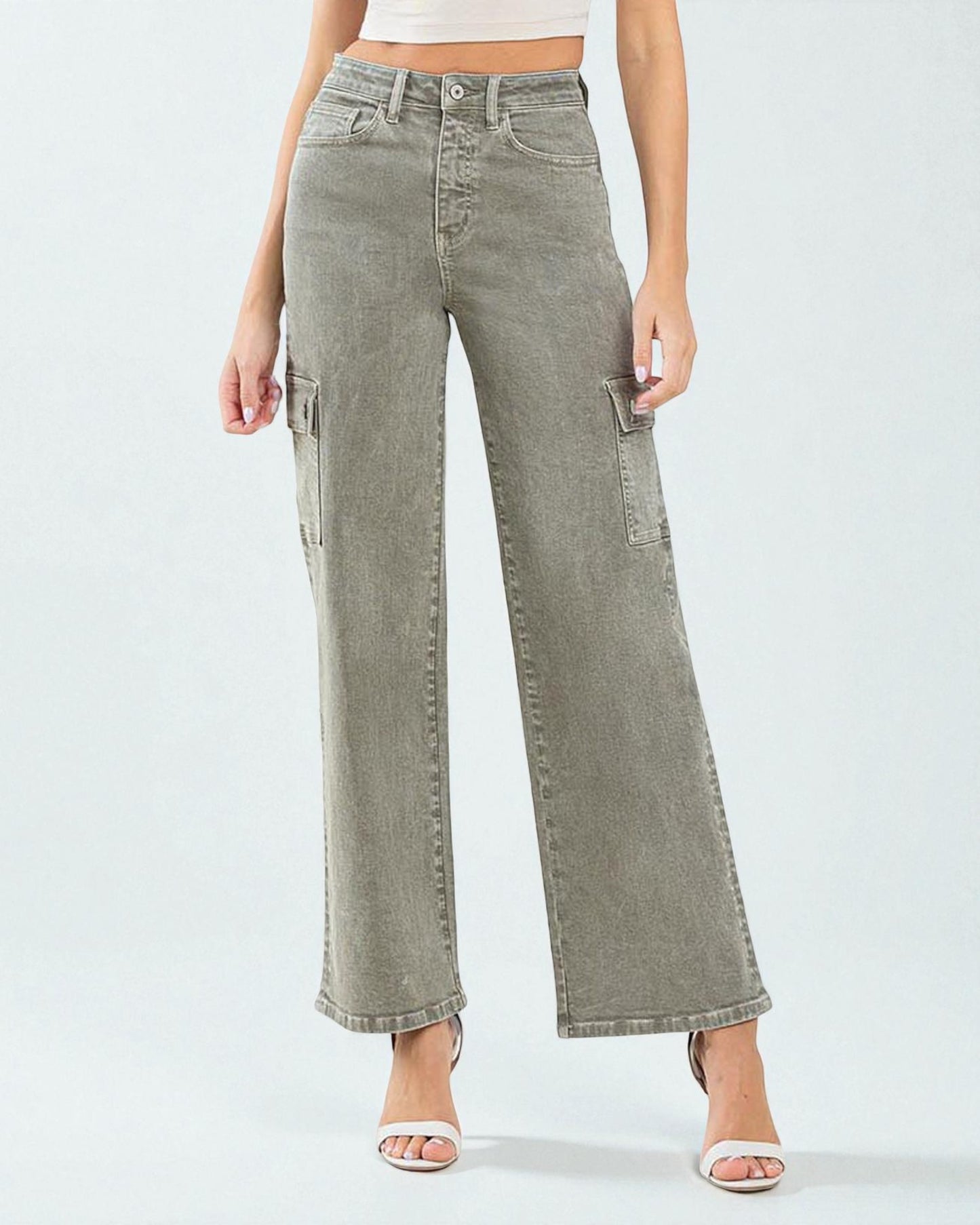 Person wearing light green wide-leg jeans on a white background