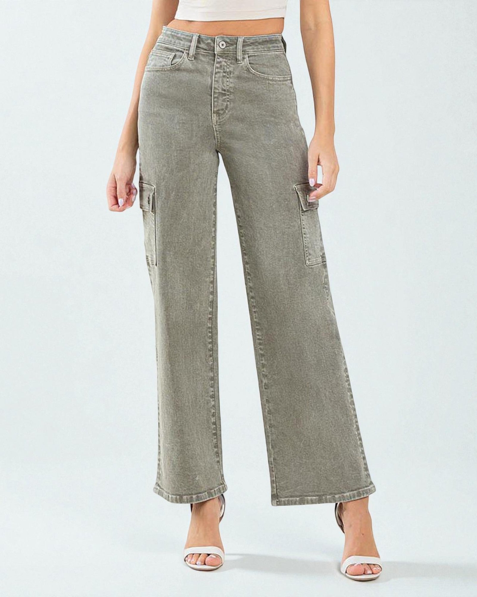 Person wearing light green wide-leg jeans on a white background