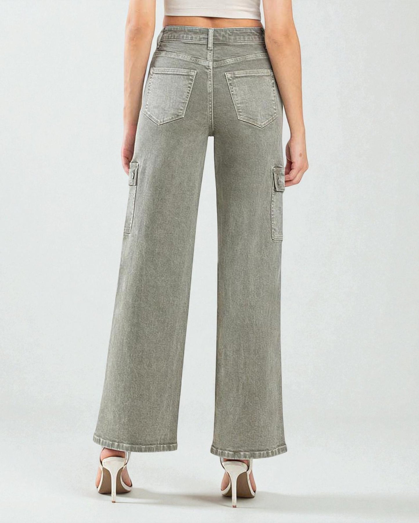 Person wearing light gray wide-leg jeans on a white background