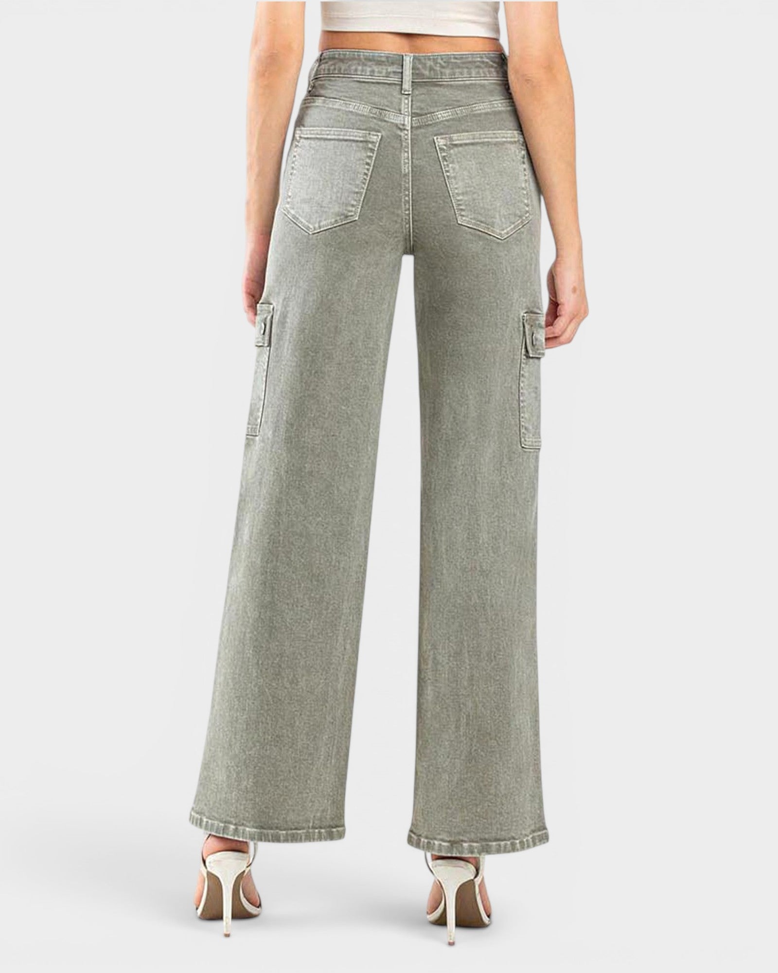 Person wearing light gray wide-leg jeans on a white background