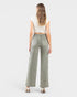 Woman wearing green wide-leg jeans on a white background