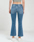 Person wearing blue flared jeans on a white background