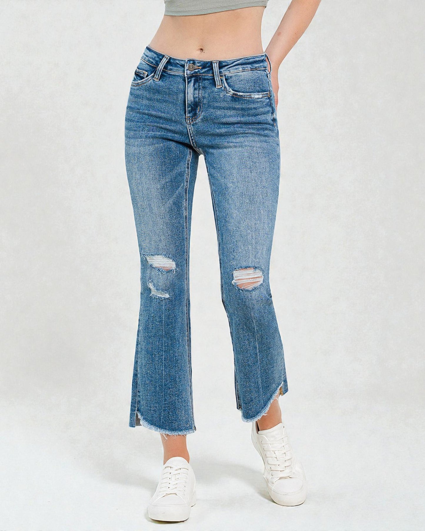 Blue jeans with slight distressing on a white background