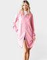 Woman wearing a pink shirt dress on a white background