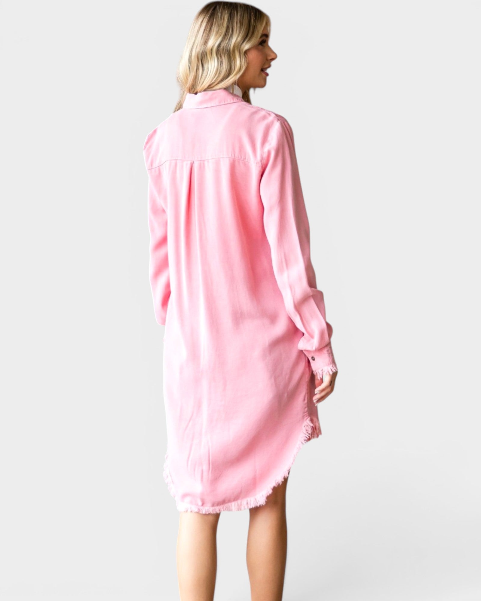 Woman wearing a pink dress against a white background