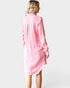 Woman wearing a pink dress against a white background