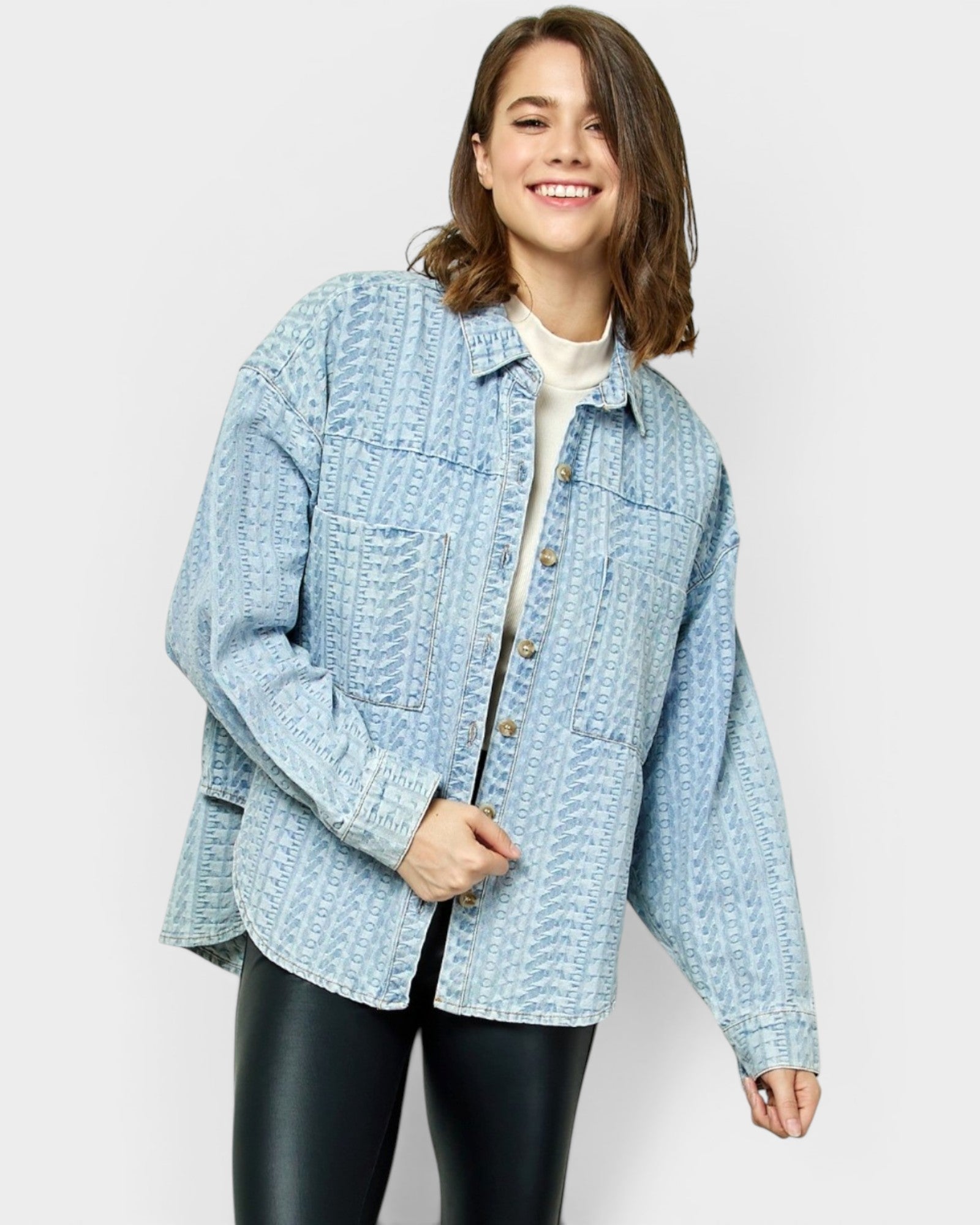 Woman wearing a light blue denim jacket on a white background