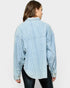 Woman wearing a light blue textured shirt on a white background