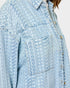 Light blue denim jacket with a textured pattern on a white background