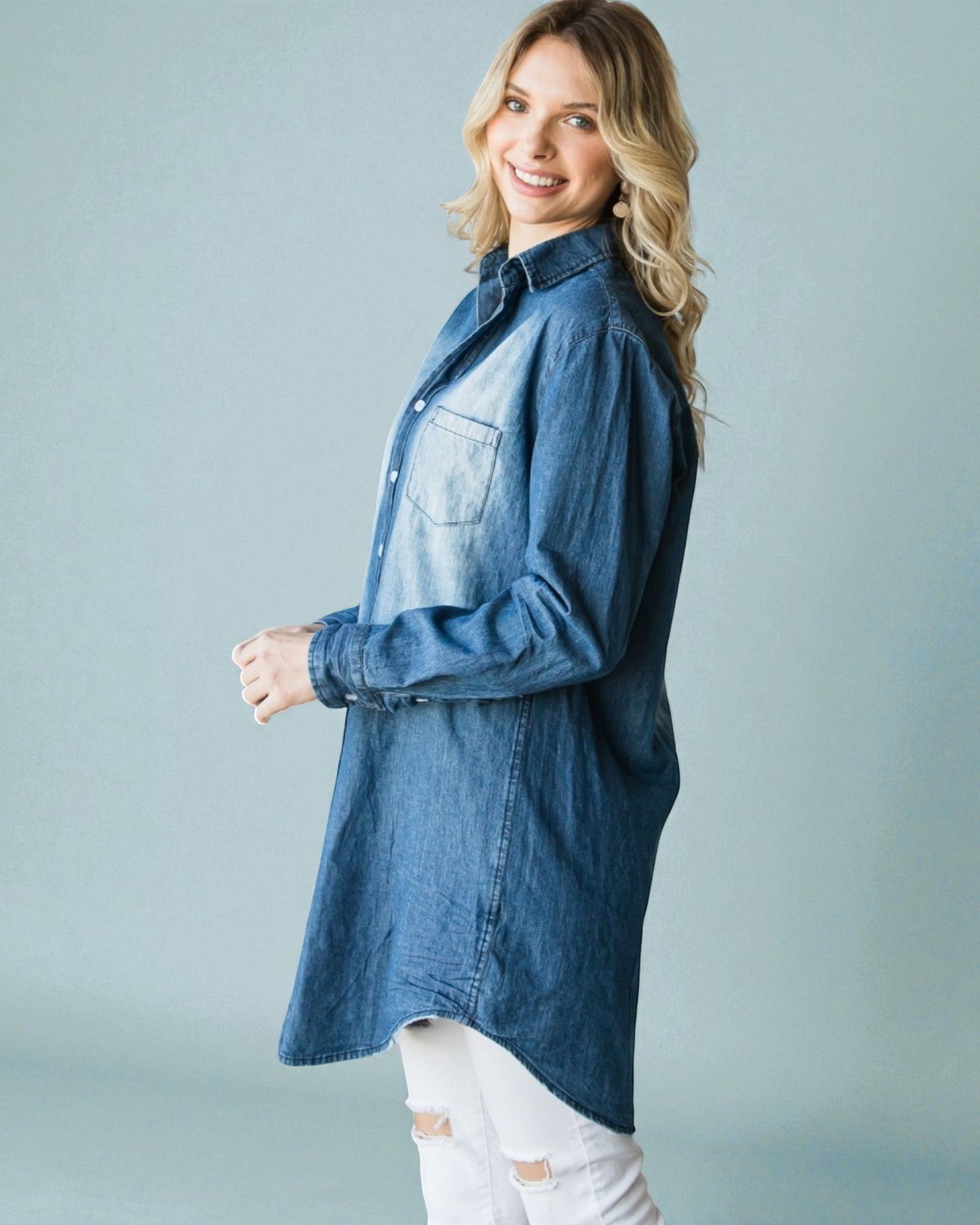 Woman wearing a blue denim shirt against a gray background