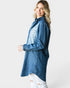 Woman wearing a blue denim shirt on a white background