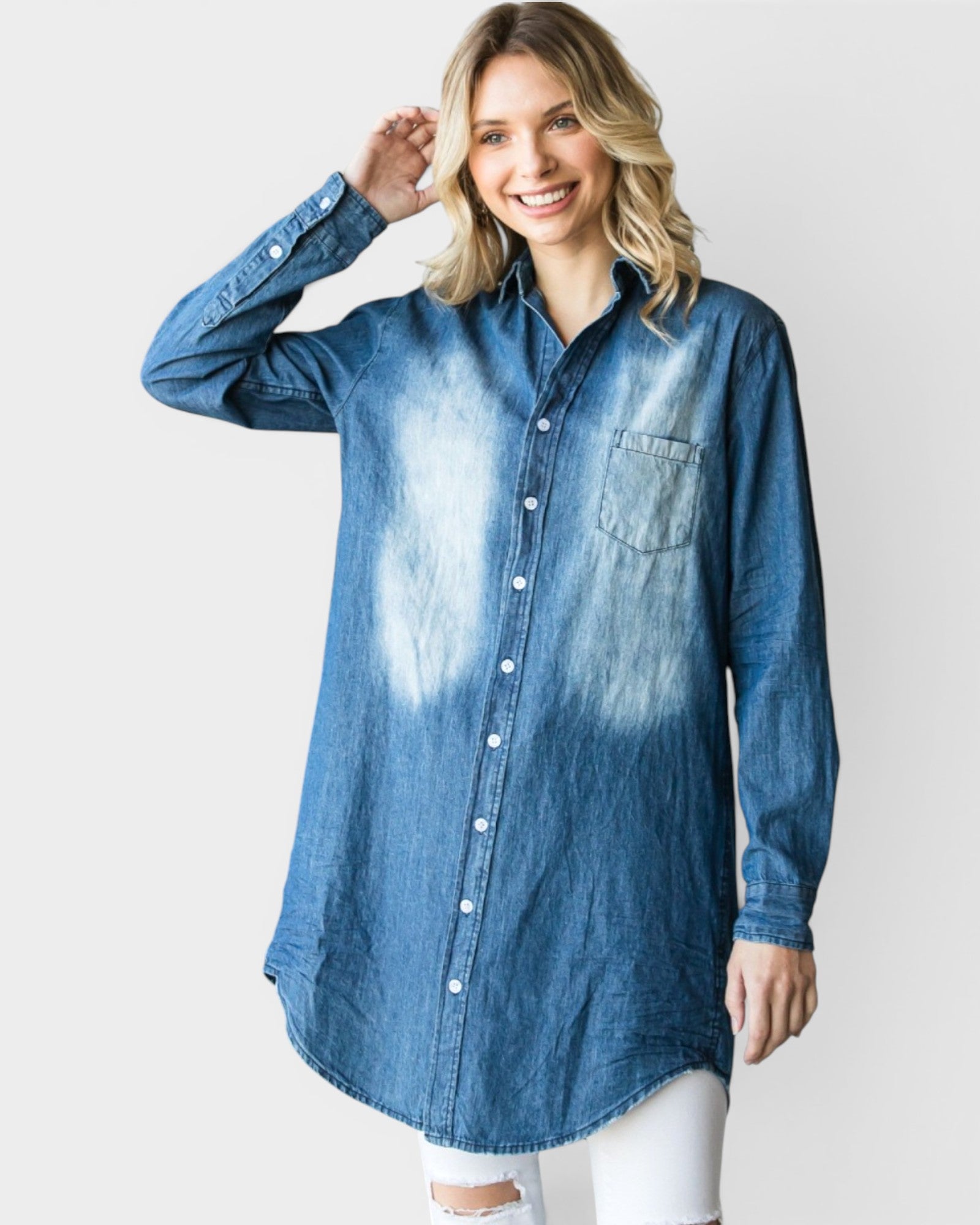 Woman wearing a blue denim shirt with tie-dye design on a white background