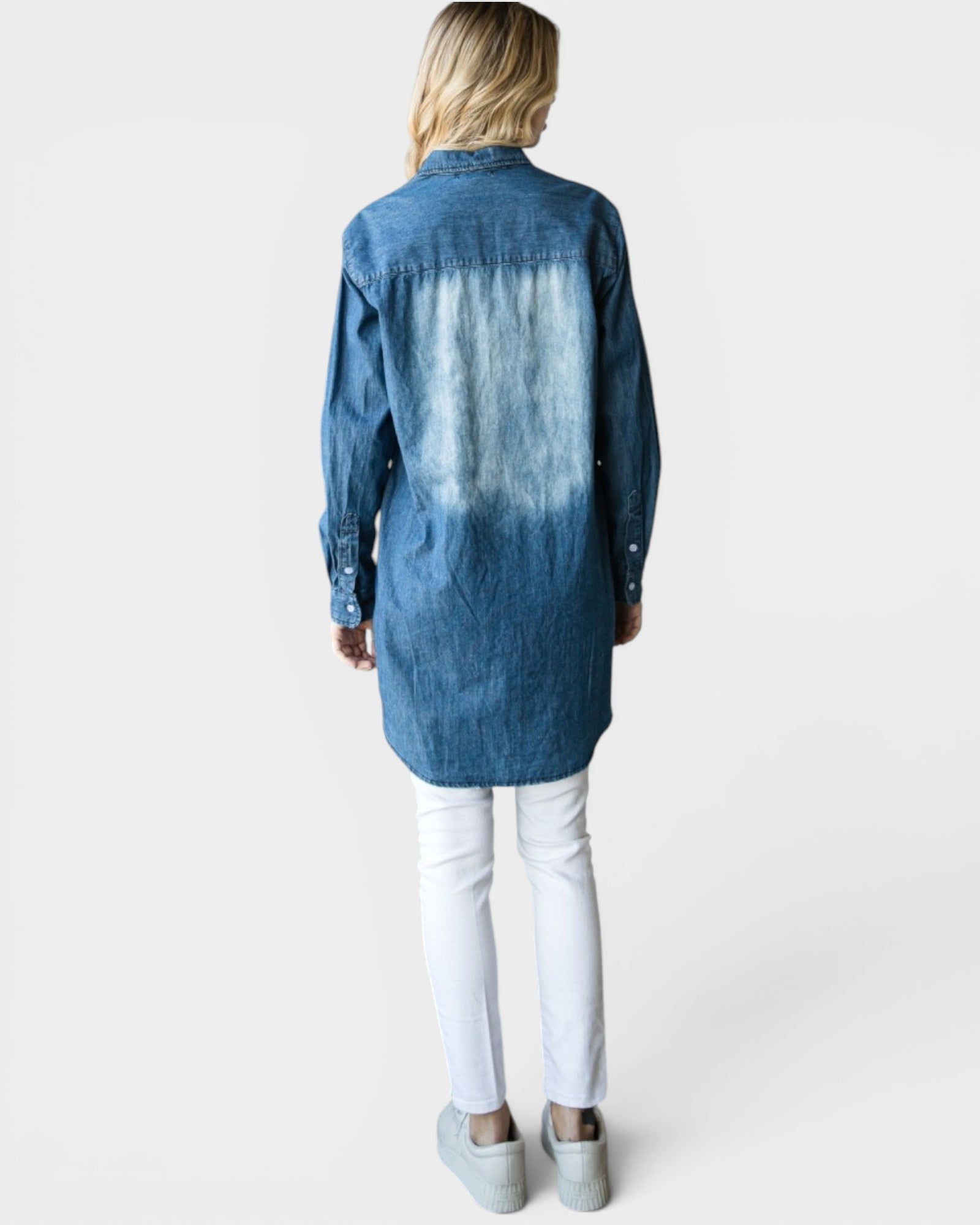 Person wearing a blue denim shirt with a white background