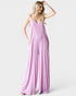 Woman wearing a pink slip dress on a white background