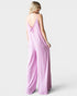 Woman wearing a pink jumpsuit on a white background