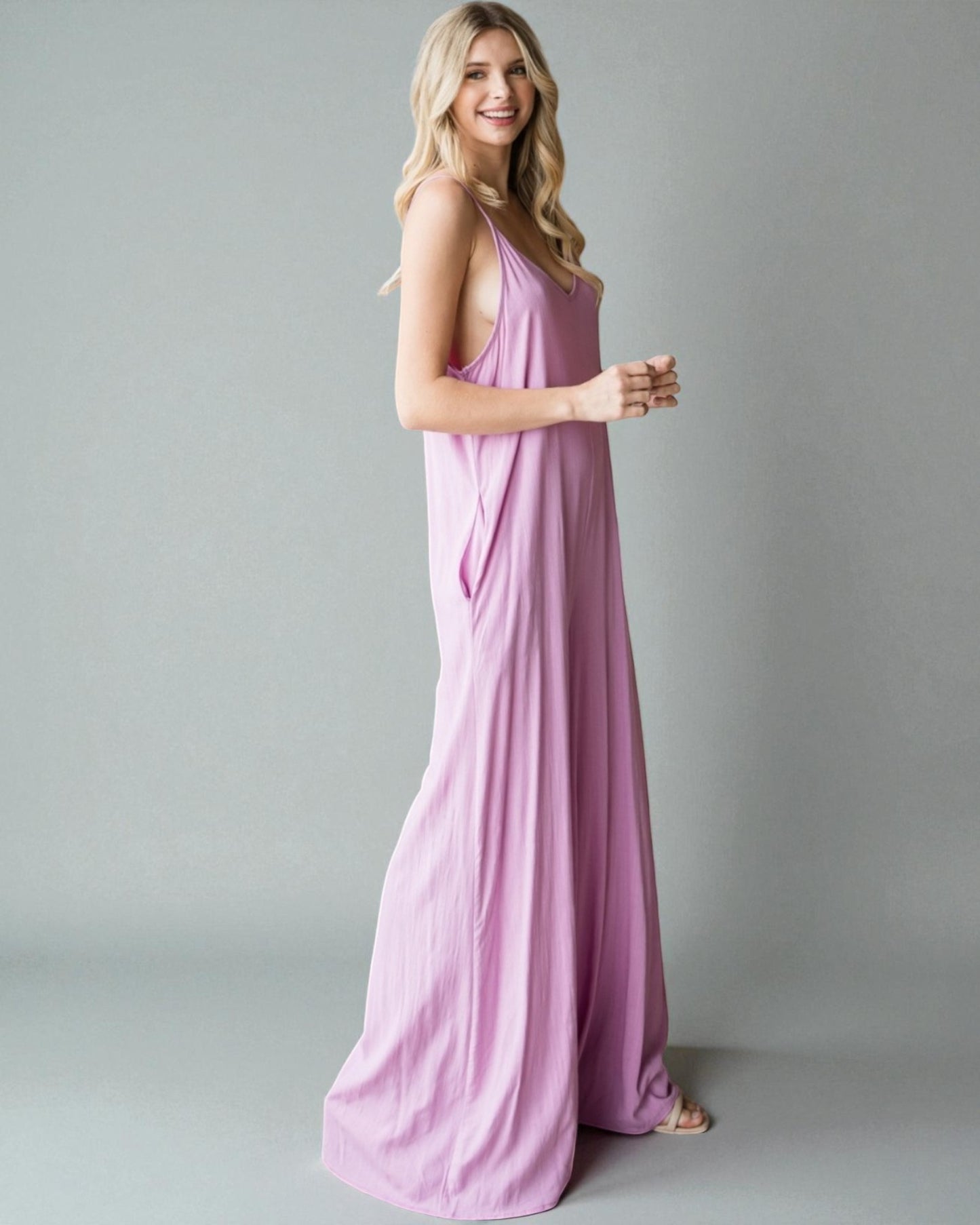 Woman wearing a pink dress against a gray background