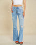 Light blue flared jeans with button details on a beige background