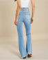 Light blue flared jeans worn by a person on a beige background