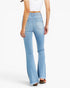 A model shown from the back wearing light-wash blue high-rise flare jeans, a white crop top, and brown sandals against a plain white studio background.
