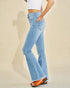 Light blue flared jeans worn by a person on a beige background