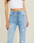 Light blue distressed jeans worn by a person on a beige background