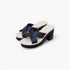 A pair of women's platform mule sandals with wide crisscross straps in a dark navy satin-like material, set against a clean white background.
