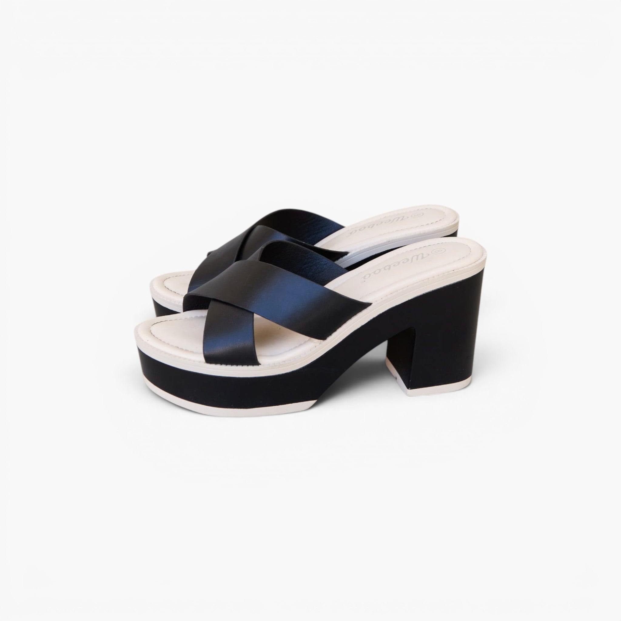 A pair of women's platform mule sandals with wide crisscross straps in a dark navy satin-like finish, set against a clean white background.