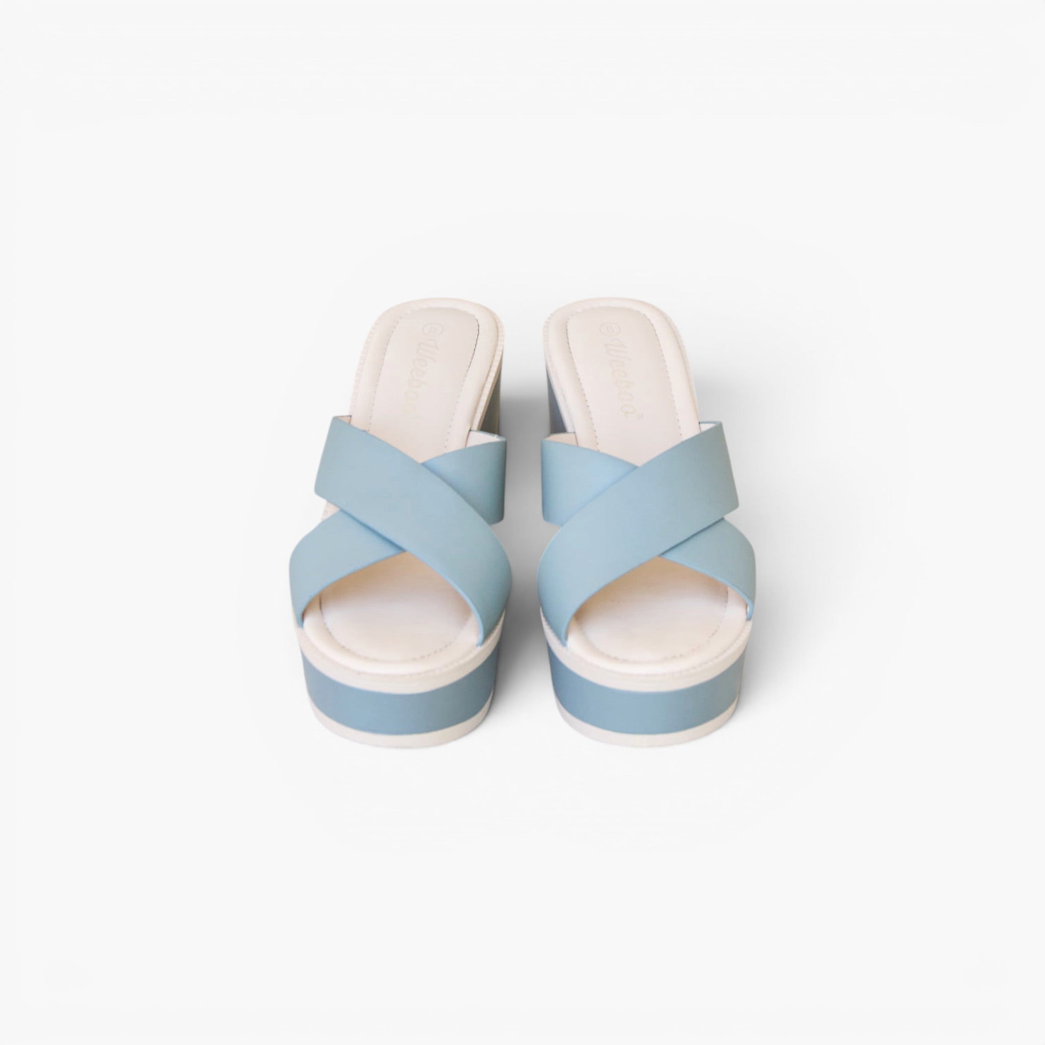A pair of women's platform slide sandals with light blue crisscross straps and white platform soles, shown from a top-down view on a white background.