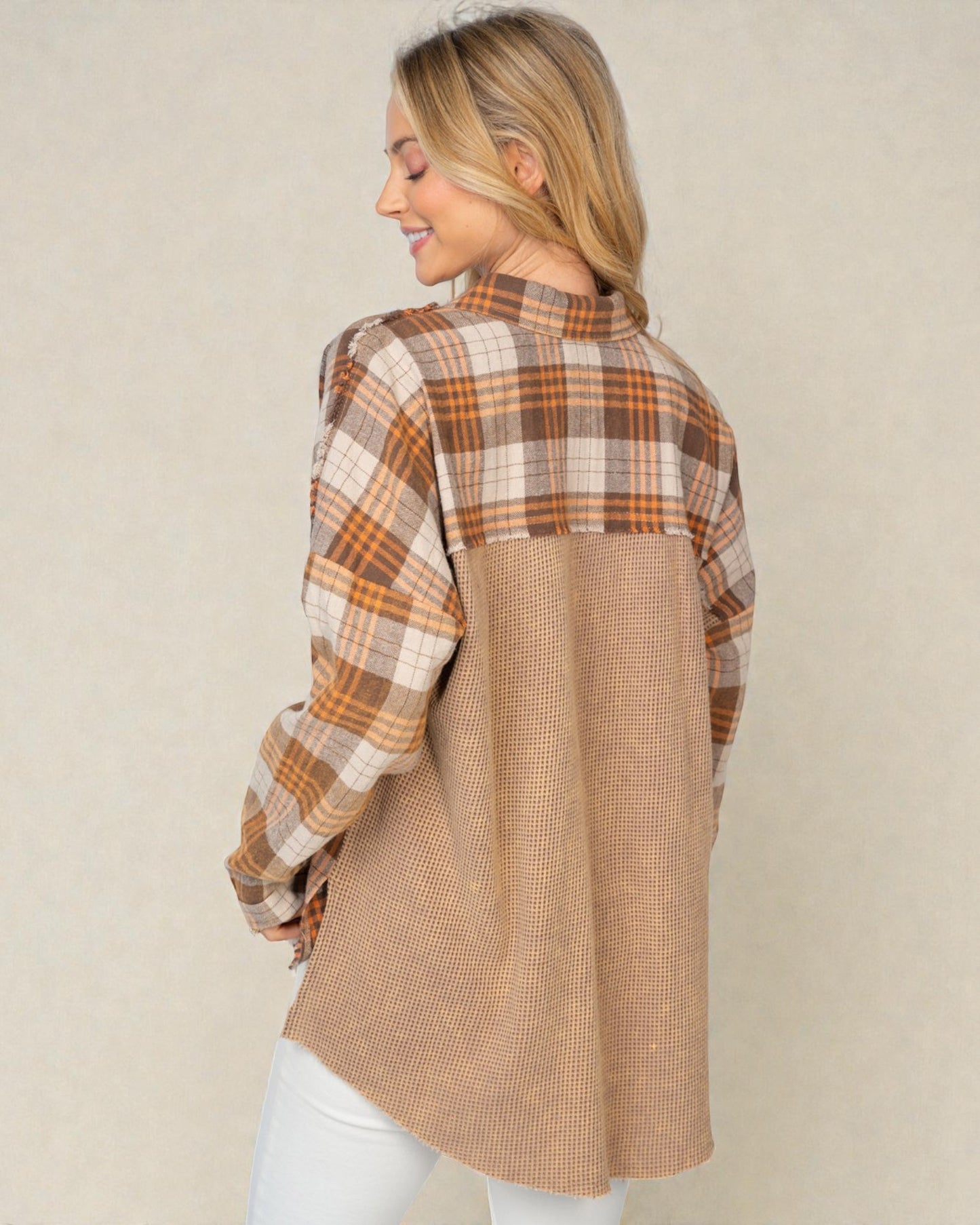 Woman wearing a plaid shirt with a beige background