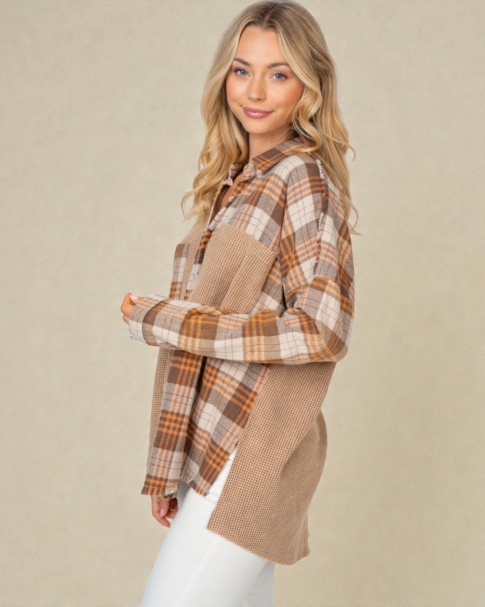 Woman wearing a plaid shirt with a beige background