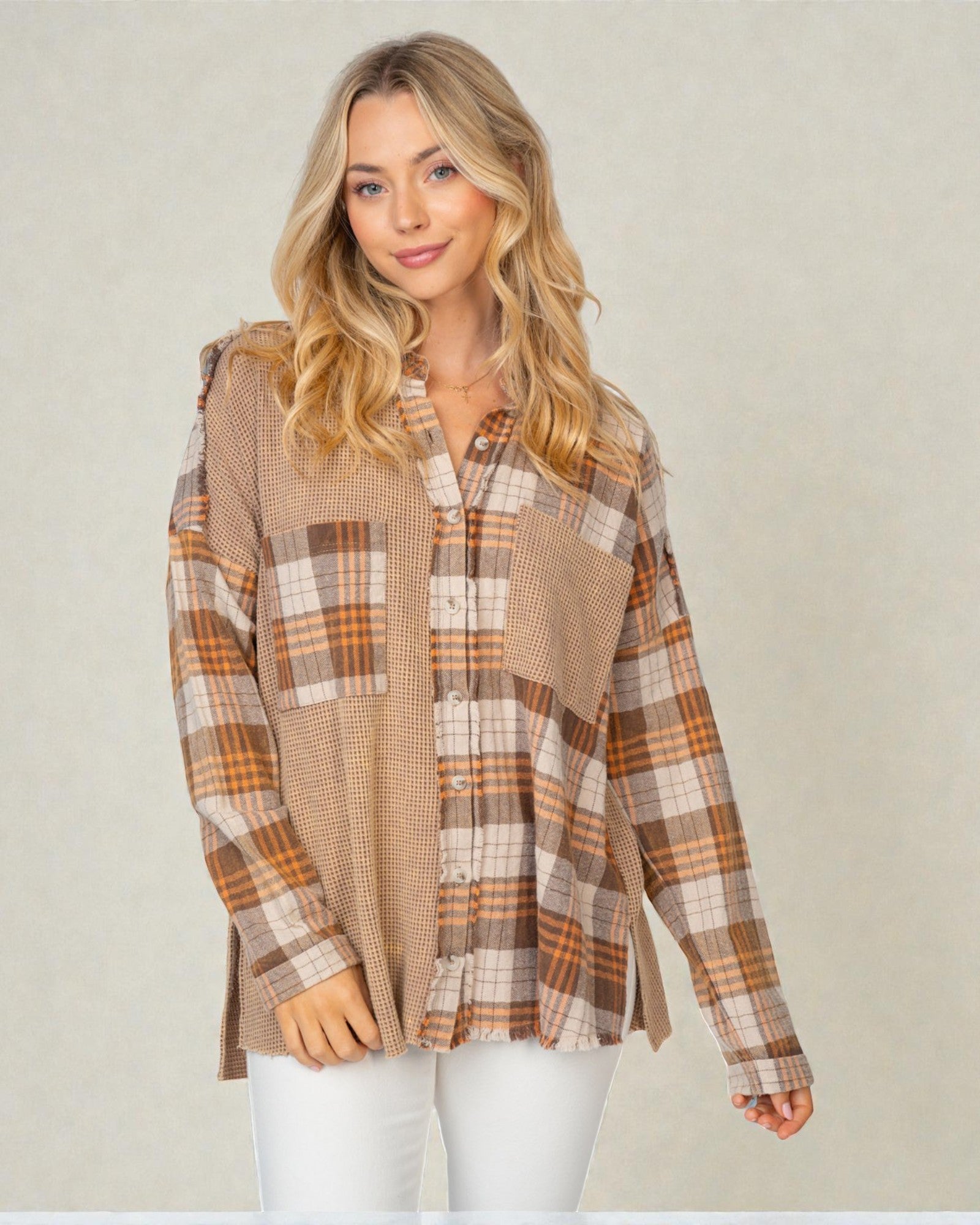 Woman wearing a plaid shirt with a neutral background