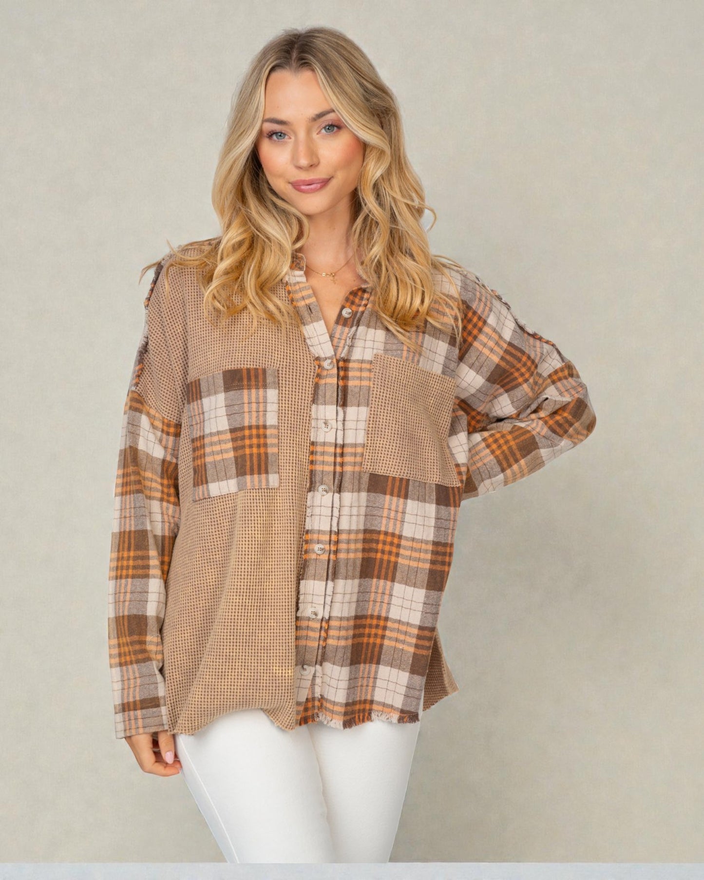 Woman wearing a plaid shirt with a neutral background