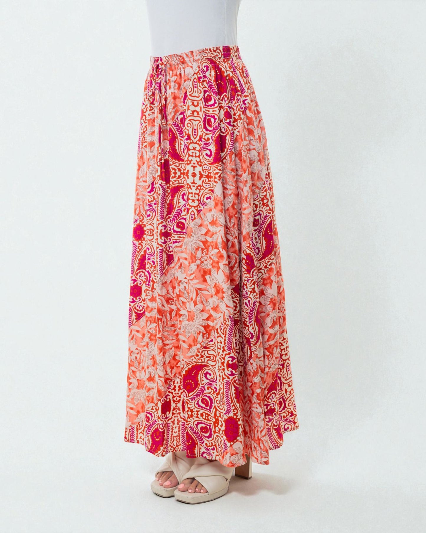 Long patterned skirt with orange and pink colors on a white background