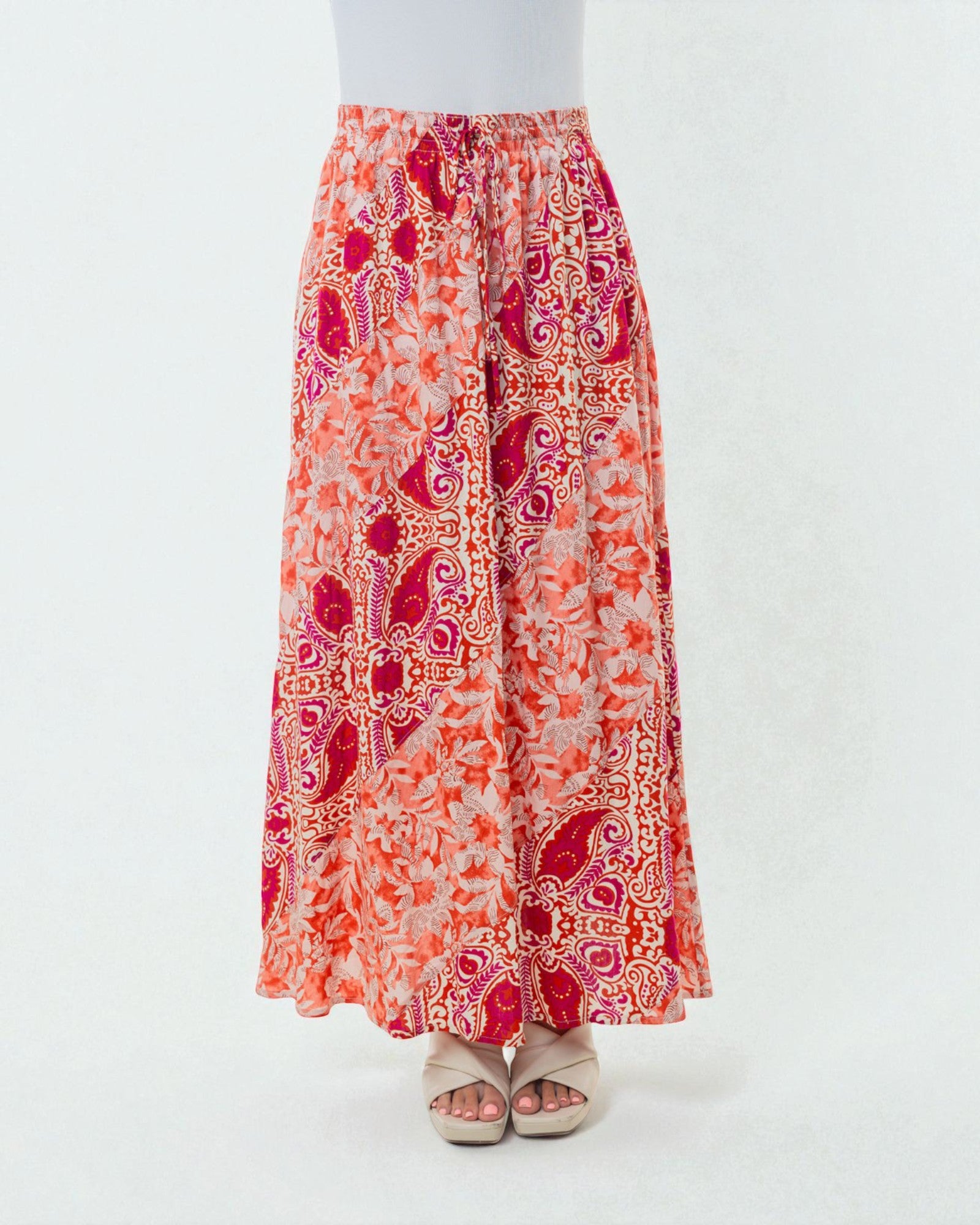 Long patterned skirt with red and orange design on a white background