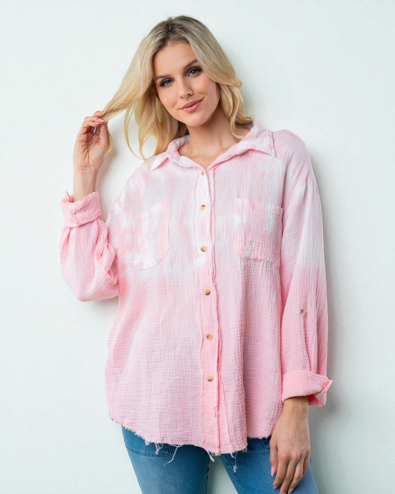 Woman wearing a pink checkered shirt against a white background