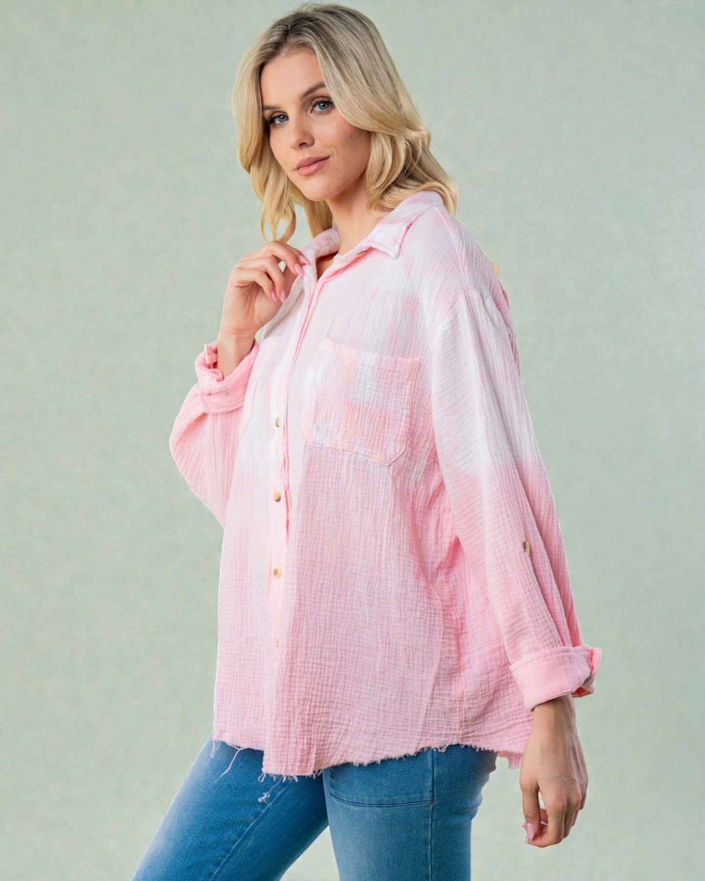 Woman wearing a pink checkered shirt against a light background