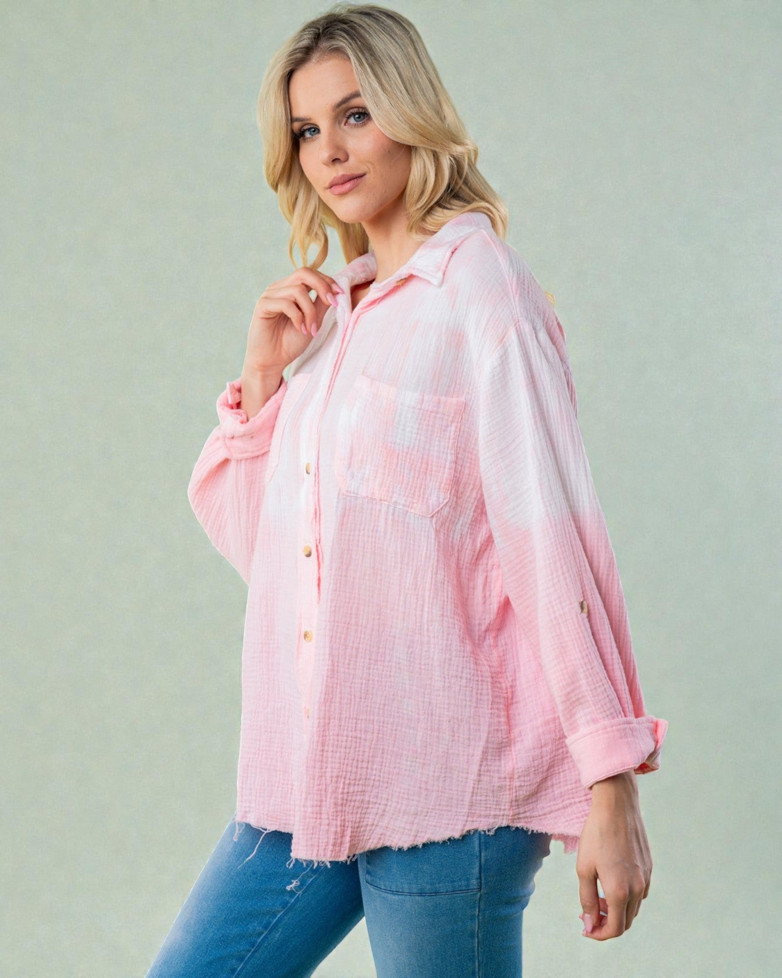 Woman wearing a pink checkered shirt against a light background