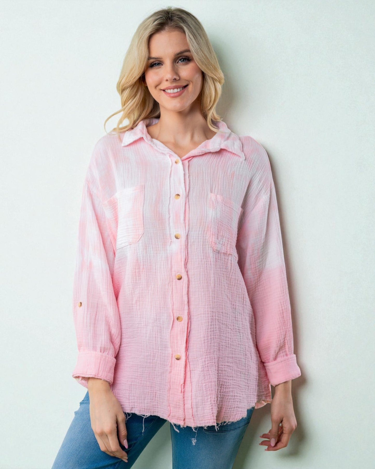 Woman wearing a pink checkered shirt against a light background