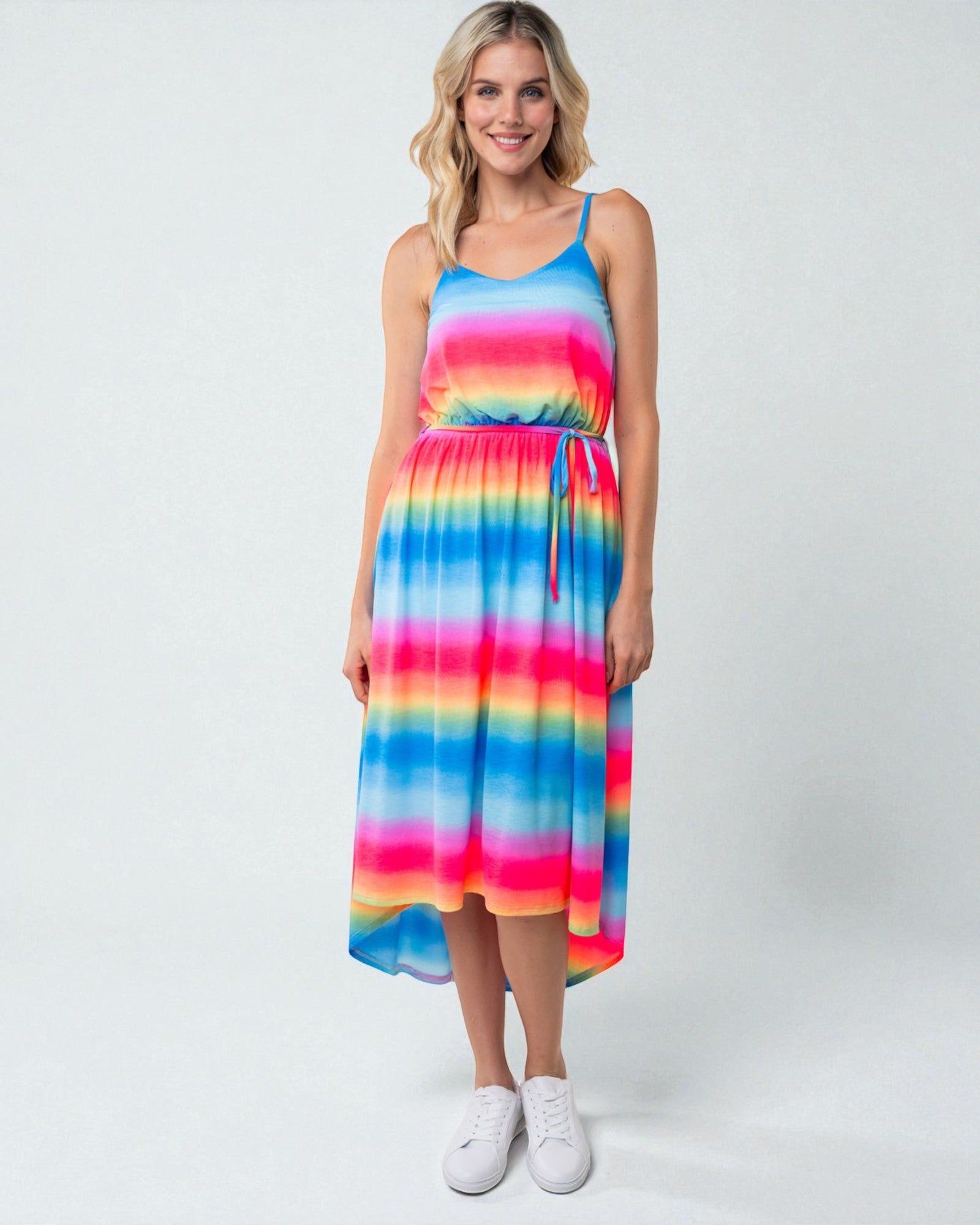 Woman wearing a colorful striped dress on a white background
