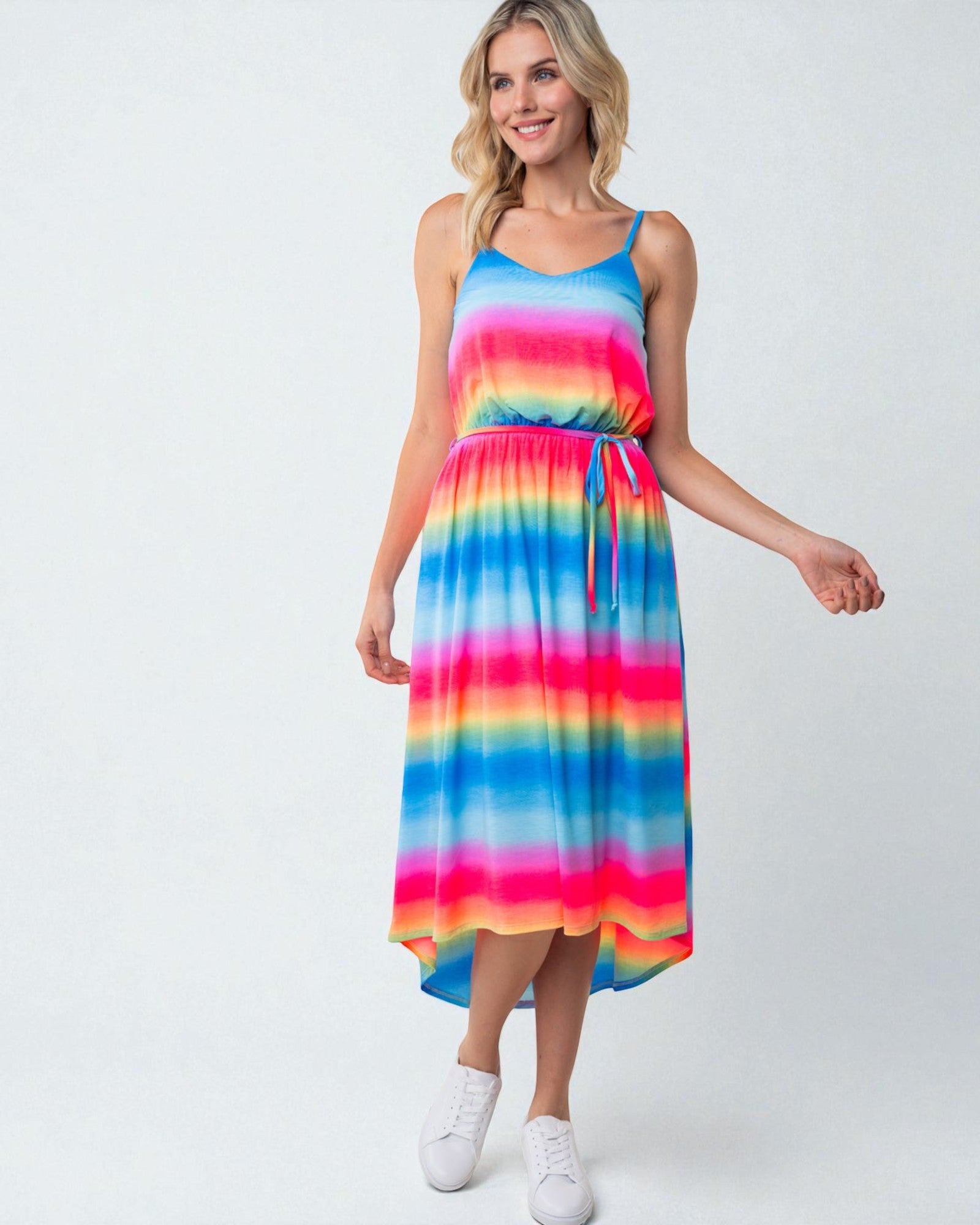 Woman wearing a colorful striped dress on a white background