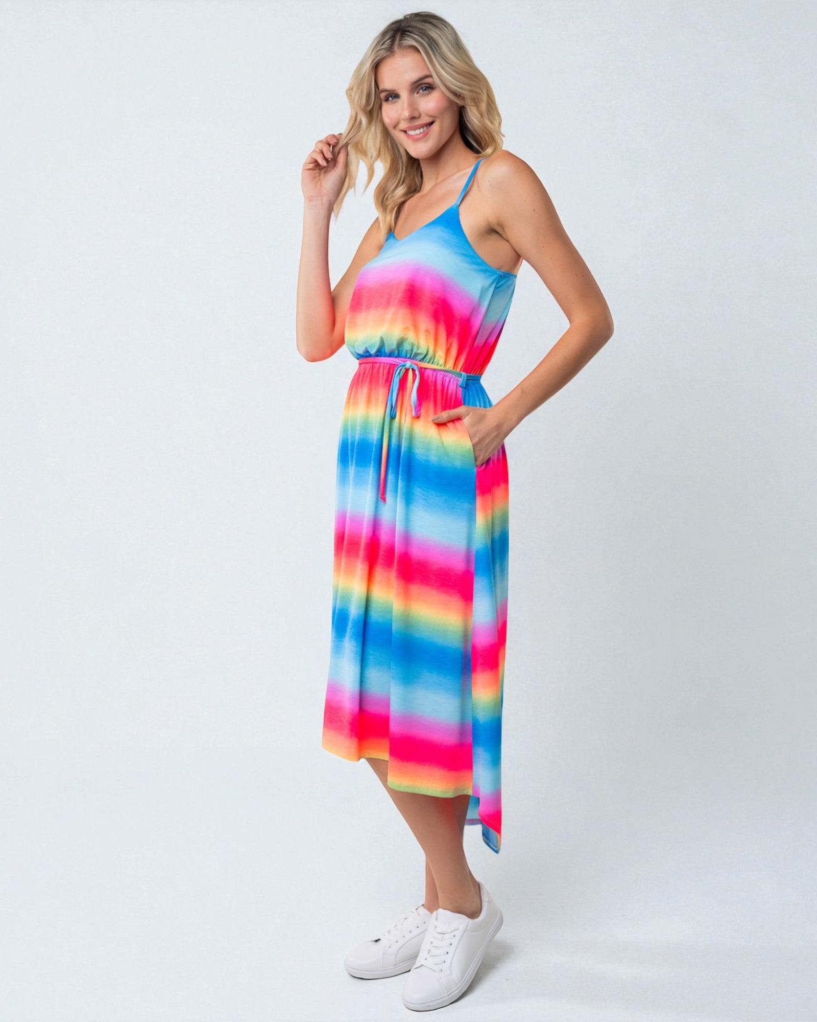 Woman wearing a colorful tie-dye dress on a white background