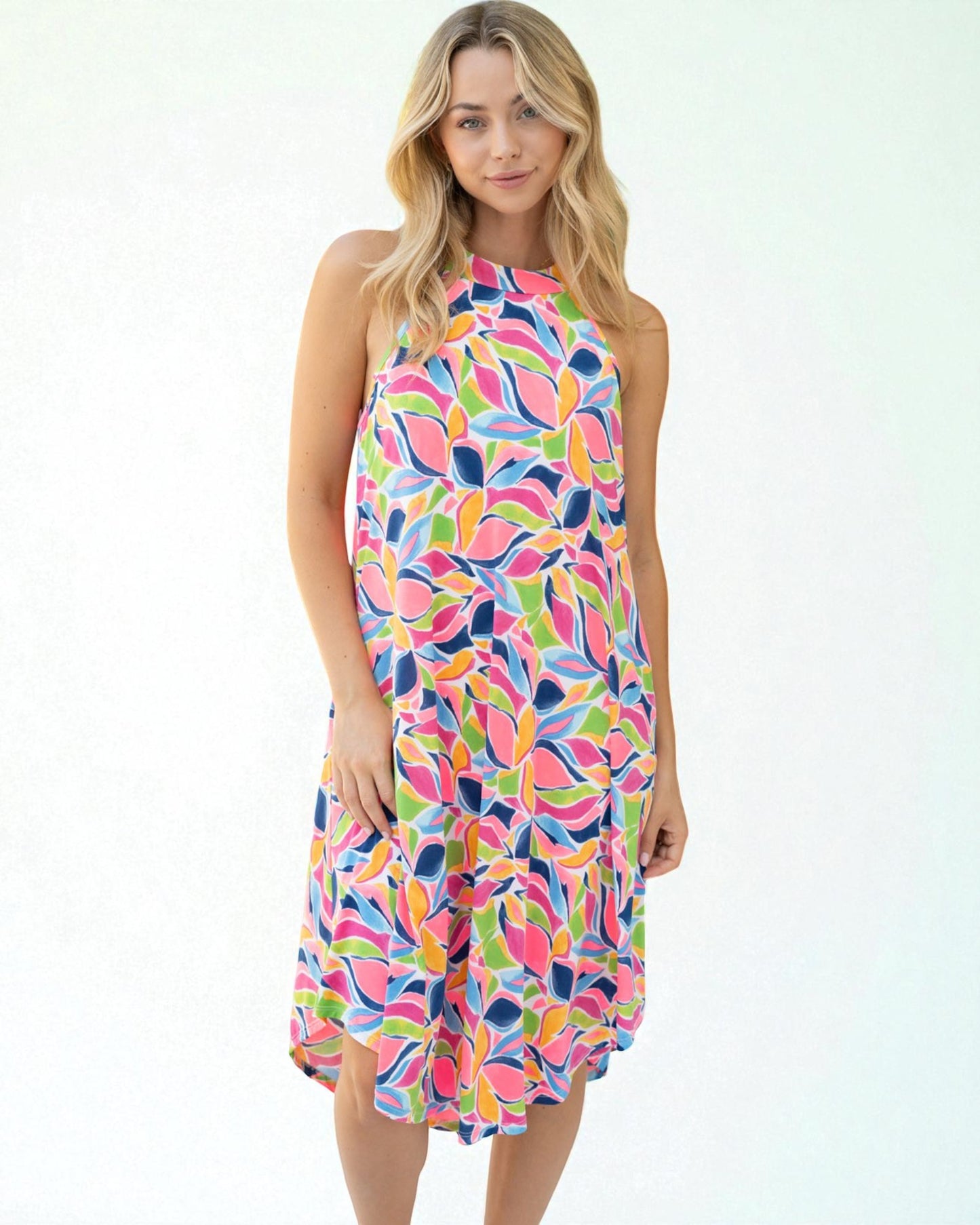 Woman wearing a colorful patterned dress on a white background