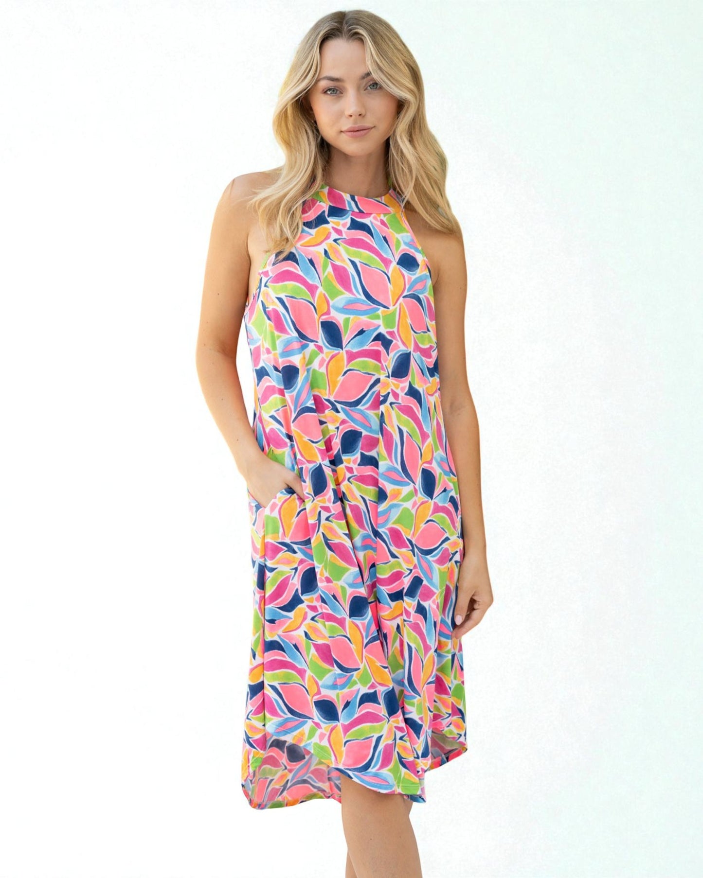 Woman wearing a colorful patterned dress on a white background