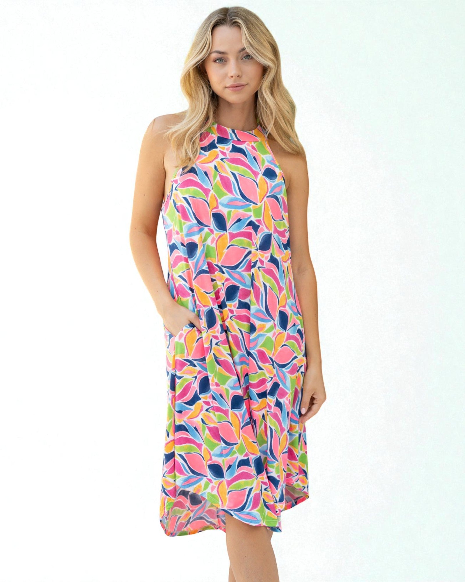 Woman wearing a colorful patterned dress on a white background