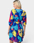 Woman wearing a colorful tropical pattern dress on a white background
