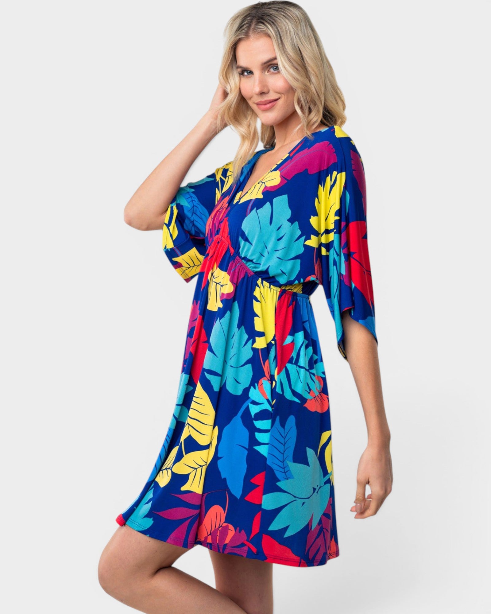 Woman wearing a colorful floral dress on a white background