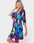 Woman wearing a colorful floral dress on a white background