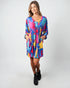 Woman wearing a colorful dress on a white background