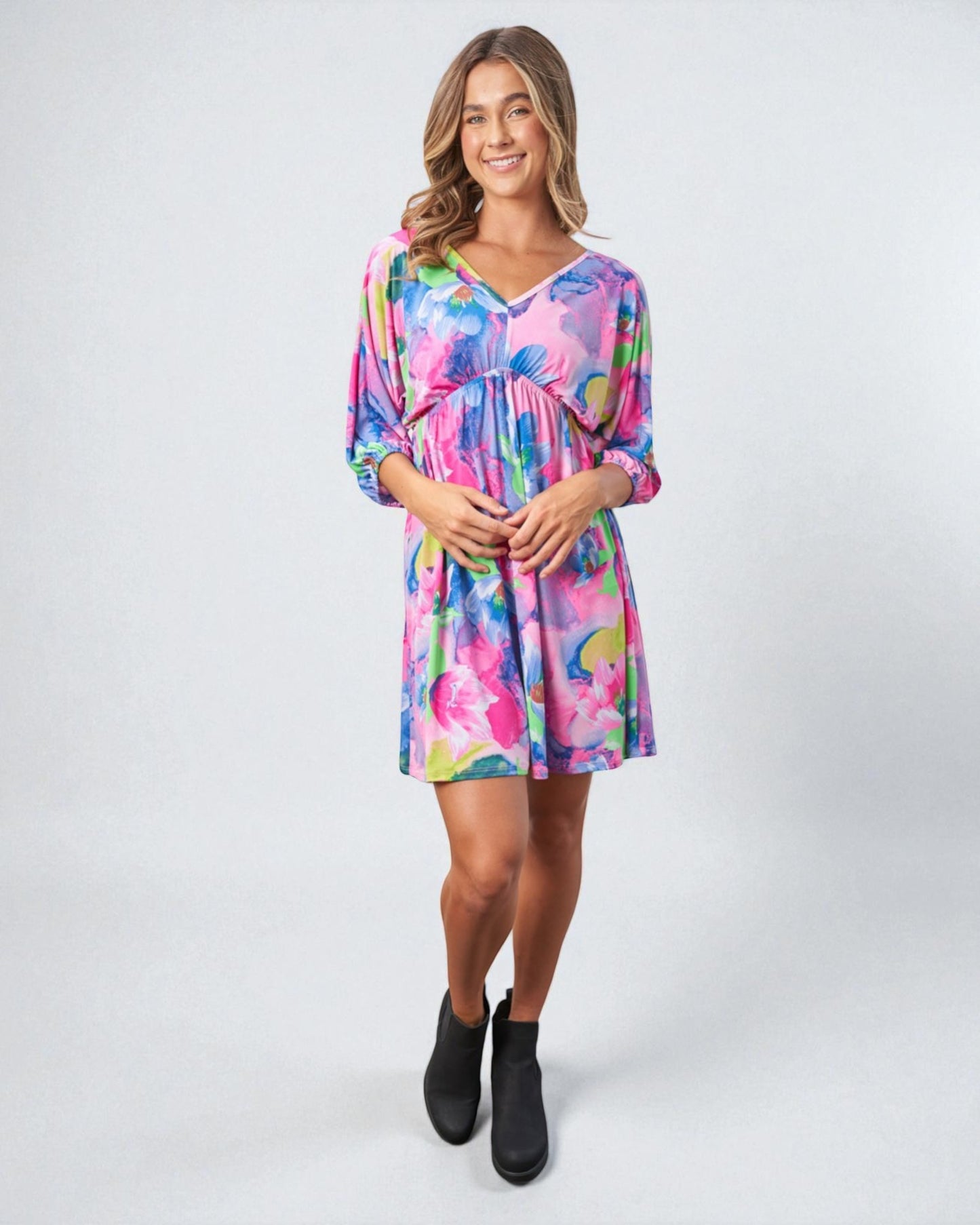 Woman wearing a colorful dress on a white background